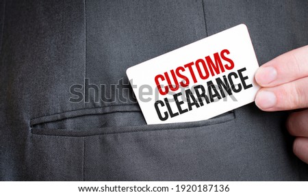 Card with CUSTOMS CLEARANCE text in pocket of businessman suit. Investment and decisions business concept.
