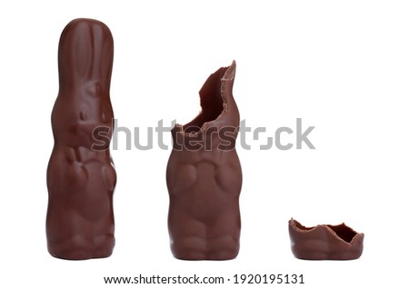 Process of eating delicious chocolate Easter bunny on white background