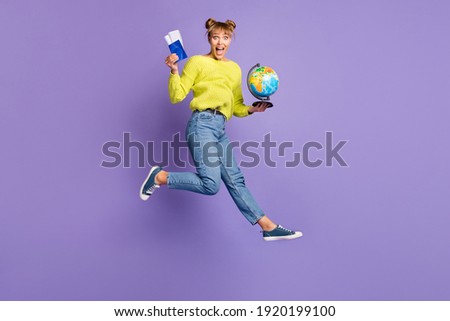 Full length body size view of lovely cheerful girl jumping holding globe flight tickets journey isolated on violet color background