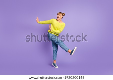 Full length body size view of pretty cheerful carefree girl jumping having fun dancing isolated over pastel violet color background