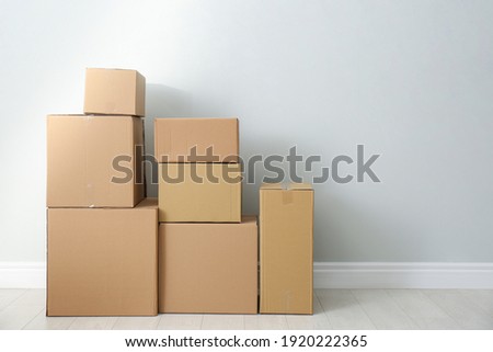 Cardboard boxes with stuff indoors, space for text. Moving day