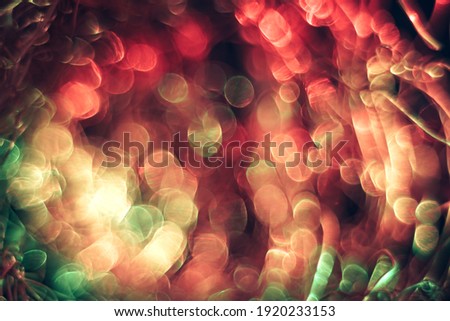 Beautiful optical abstract multicoloured  bokeh in the darkness  background.
