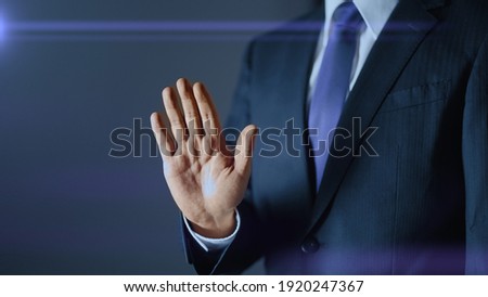 A businessman who makes a gesture to refuse