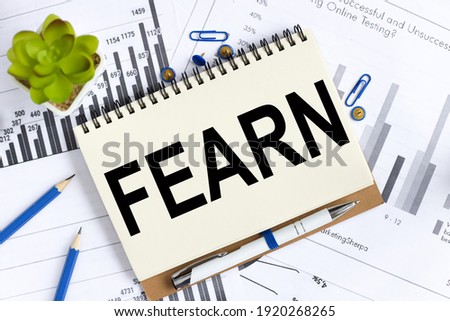 fearn. Text on white notepad paper on light background