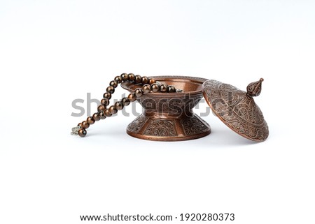 Ramadan concept with prayer beads and plate. Royalty-Free Stock Photo #1920280373