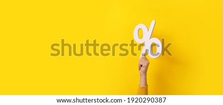 hand holding 3D  percentage symbol over yellow background, panoramic image Royalty-Free Stock Photo #1920290387