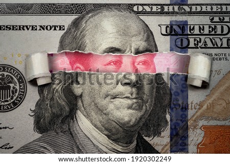Torn bill revealing Chinese Yuan inside American Dollar. Ideas for Competition between China and USA, Risk of war, Taking over, Economy overtake, Changing world currency from US dollar to Chinese yuan Royalty-Free Stock Photo #1920302249