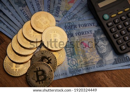 Financial concept. Hungarian forint paper money denomination and bitcoin. Bank image and photo. 