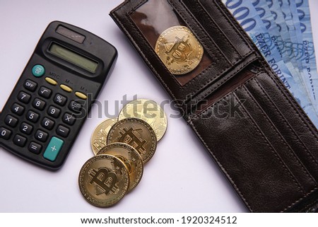 Financial concept. Hungarian forint paper money denomination, wallet and bitcoin on white isolated background. Bank image and photo.