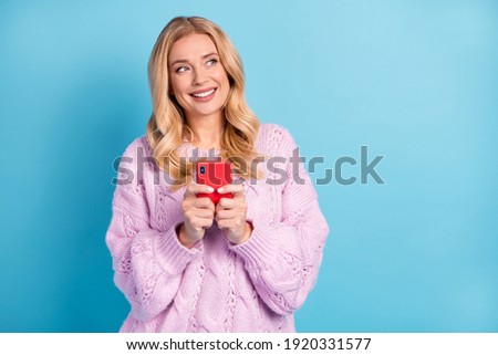 Photo portrait of blonde woman browsing internet with smartphone looking copyspace isolated vivid blue color background