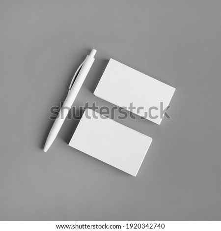 Template for ID. Blank business cards and pen on gray paper background. Flat lay.