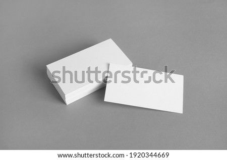Blank white business cards on gray paper background. Mockup for branding identity. Template for graphic designers portfolios. Royalty-Free Stock Photo #1920344669