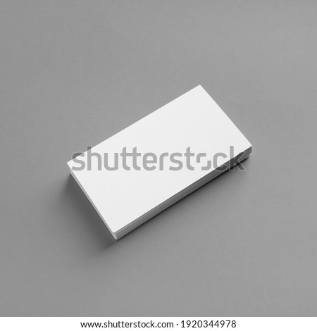 Photo of blank business cards on gray paper background. Template for ID. Mock-up for branding identity.