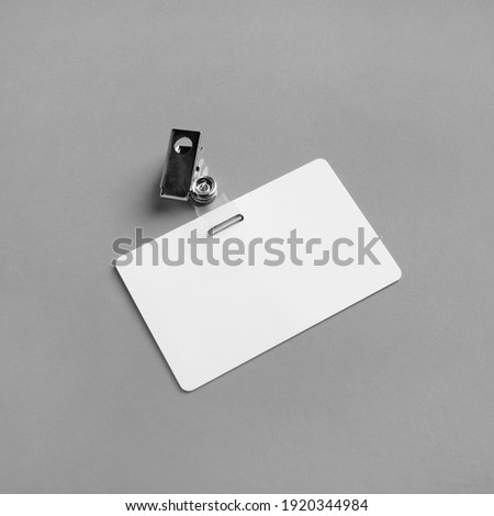 Blank plastic badge mockup on gray paper background. Empty ID mock up. Copy space for text. Blank template for for ID.