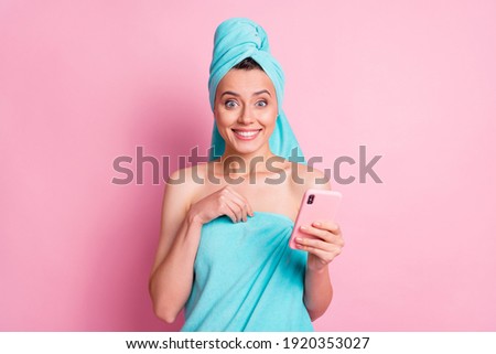 Portrait of nice sweet young lady hold towel telephone wear teal bath clothes isolated on pastel pink color background