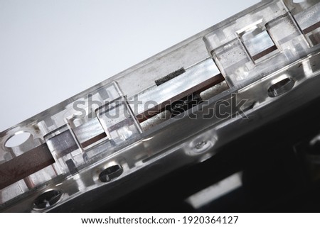 Close-up of a classic audio cassette on a gray background. Vintage style background