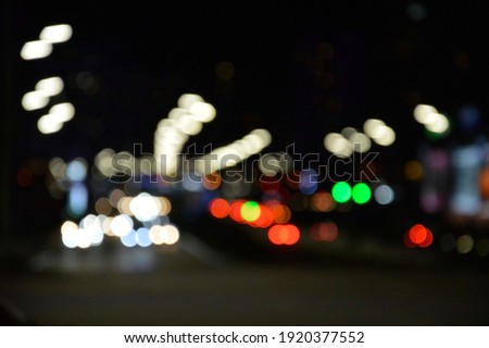 blurred lights of the night city red blue yellow on a black background festive mood bright abstraction background on the desktop