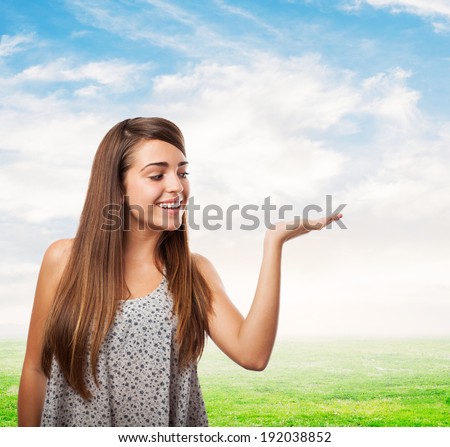 portrait of pretty young woman holding something on her hand