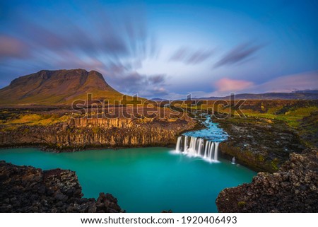 Thjofafoss waterfall located on the river Thjorsa in the south of Iceland photographed at sunset. Long exposure.