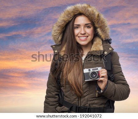beautiful young woman hiker taking a photo with the camera