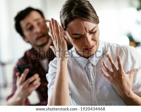 Husband and wife are arguing at home. Angry man is yelling at his wife Royalty-Free Stock Photo #1920434468