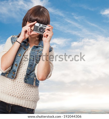 portrait of a pretty young woman taking a photo
