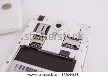 a smartphone with removed cover and battery on white background phone repair
