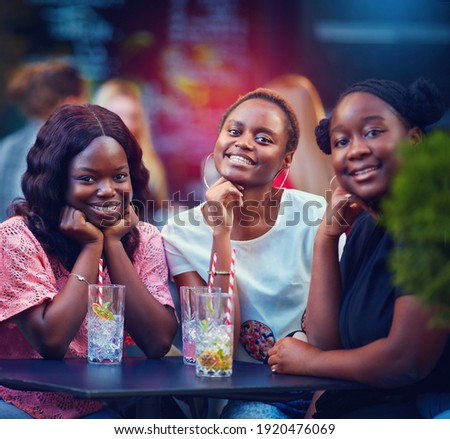 a Group of African American Friends having fun at the street restaurant, summer party Royalty-Free Stock Photo #1920476069
