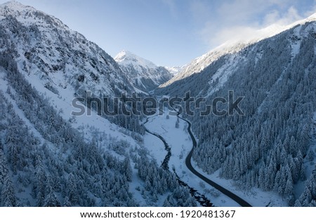 Stunning aerial shot of a snowy valley in the alps during winter