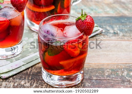 Traditional Pimms cocktail with lemonade, strawberries, cucumber, orange and mint 