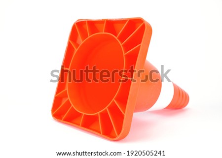 Traffic cone lying on its side and turned by its base towards the shooting point