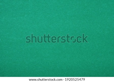 Plain green background. Green cardboard. Green paper texture background. Abstract geometric flat composition. Copy spaces