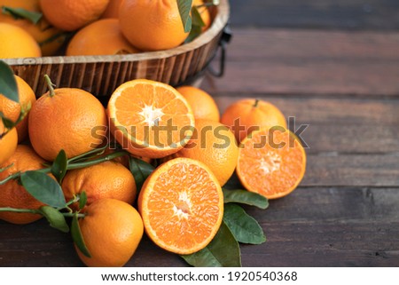 Orange fruit with green leaves on the  wood.  Home gardening. Mandarine oranges. Tangerine  oranges. Orange color. Fresh orange juice. Royalty-Free Stock Photo #1920540368