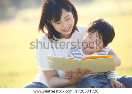 Image of parents and children reading a book 