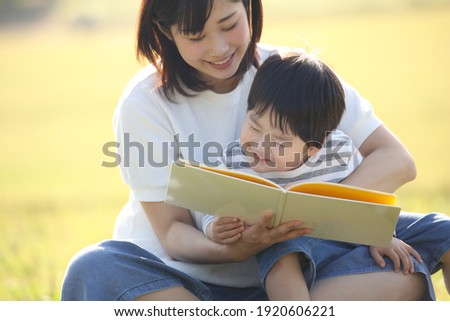 Image of parents and children reading a book 