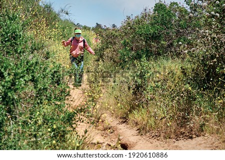 adult woman trekking with protective mask on, vacation concept in covid time