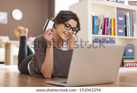Happy woman doing online shopping at home  Royalty-Free Stock Photo #192063296
