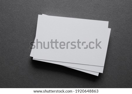 Mock up a stack of blank white cards, a grey table, space for text or a template Royalty-Free Stock Photo #1920648863