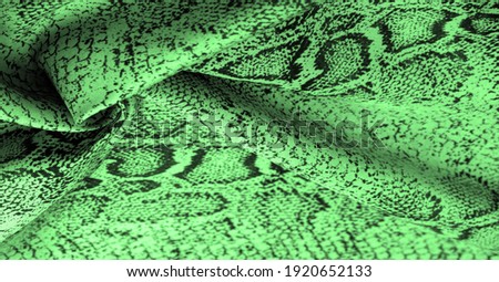 Texture, background, pattern, fabric with a green snake skin pattern, African fabric, designer photo - safari in the country of Africa