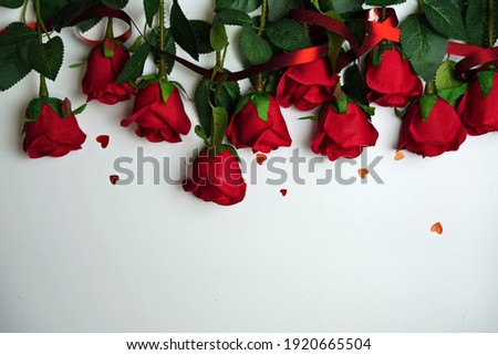 Red roses and heart shape ornaments on white background Royalty-Free Stock Photo #1920665504