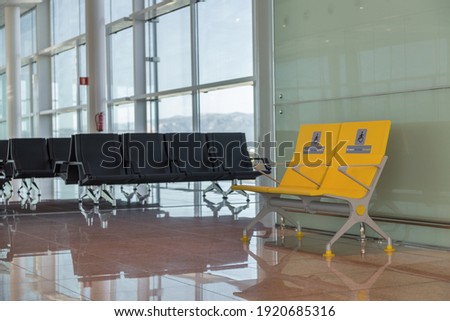 Empty priority seats in international airport reserved for disabled people. Normal and yellow disabled seats in the waiting area before boarding