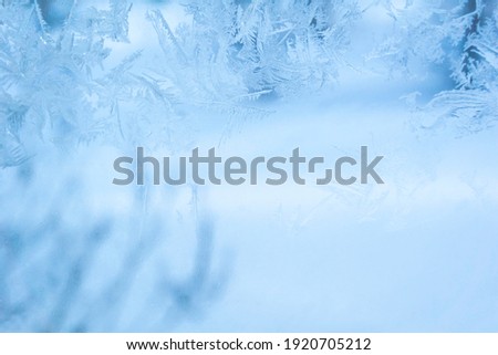 Winter background, frosty patterns on the window glass. Wallpaper for decoration, new year's eve picture.