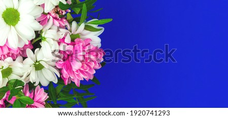 Background of sprig flowers on a blue background, copy space, border with flowers, festive bouquet composition