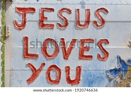 Jesus loves you written on old car door