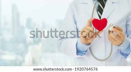 ้heart in doctor's hand. cardiology or heart health care concept. wide view and copy space.