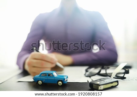 The insurance agent signs a document. Car insurance policy. Auto insurance policy. Forms registration of the contract. Royalty-Free Stock Photo #1920808157