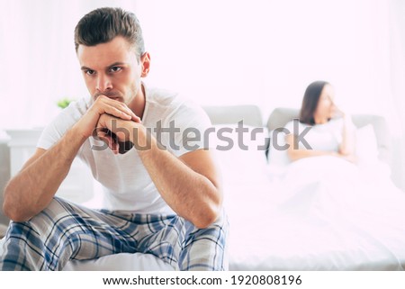 Young unhappy married couple in bedroom. Serious quarrel in family during covid-19 quarantine Royalty-Free Stock Photo #1920808196