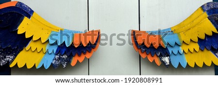 Drawn wings by wood on a wall. Background with wings. 