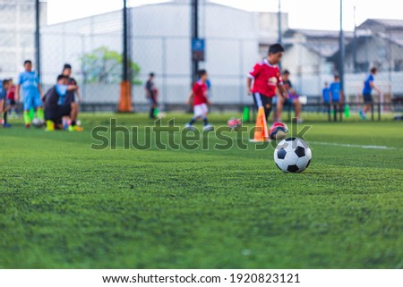 Soccer ball tactics cone on grass field with for training background Training children in Soccer