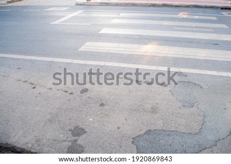 The road surface is at a pedestrian crossing for crossing the road.